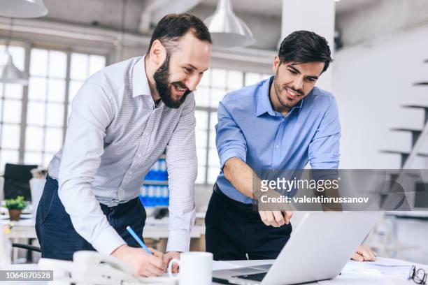 two colleague discussing new project - sales manager stock pictures, royalty-free photos & images