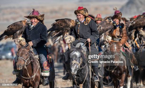 portrait of an "eagle hunter" at the golden eagle hunter festival, ölgii, west mongolia - golden eagle stock-fotos und bilder