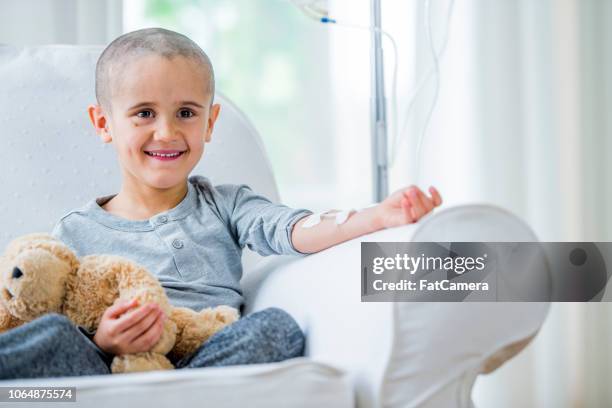 little boy in cancer recovery - infusion chair hospital stock pictures, royalty-free photos & images