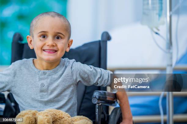 small boy with cancer in wheelchair - child cancer stock pictures, royalty-free photos & images