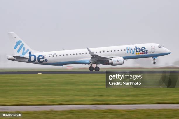 Flybe Embraer ERJ-195LR with registration G-FBEG is landing at Amsterdam Schiphol International Airport in the mist in The Netherlands. Flybe...