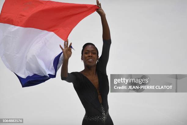 France's Vanessa James poses on the podium after winning first place of the pair free skating during the Internationaux de France ISU Grand Prix of...