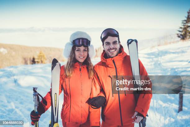 porträt des paares im skiurlaub - man standing in the snow stock-fotos und bilder