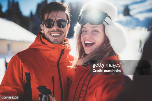 couple on winter holiday taking selfie - skier portrait stock pictures, royalty-free photos & images
