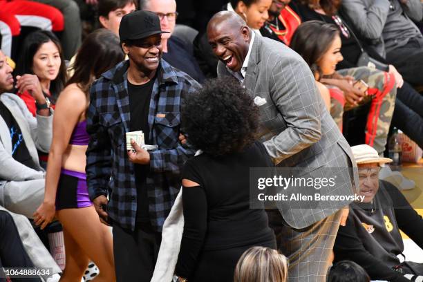 Denzel Washington, Magic Johnson and Pauletta Washington attend a basketball game between the Los Angeles Lakers and and the Minnesota Timberwolves...