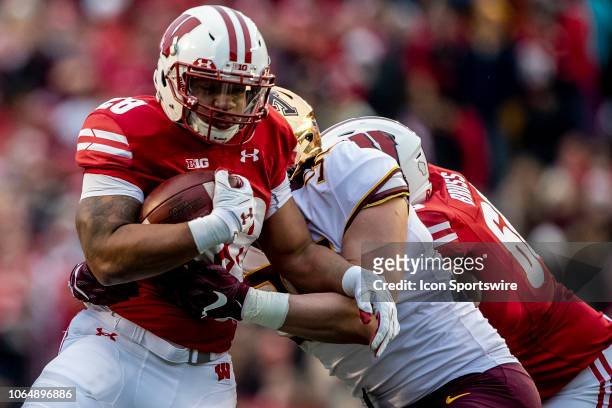 Wisconsin Badgers running back Taiwan Deal looks for running room during an college football game between the Minnesota Golden Gophers and the...