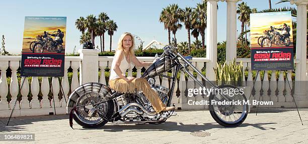 Actress Sheree Wilson poses on a motorcycle for the film "The Easy Rider: The Ride Back" during opening day of the 2010 American Film Market at the...