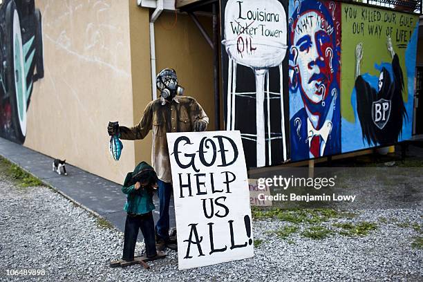 Mannequins covered in oil and large scale political murals cover Bobby Pitre's Southern Sting tattoo parlor located in Larose, LA, along a road...