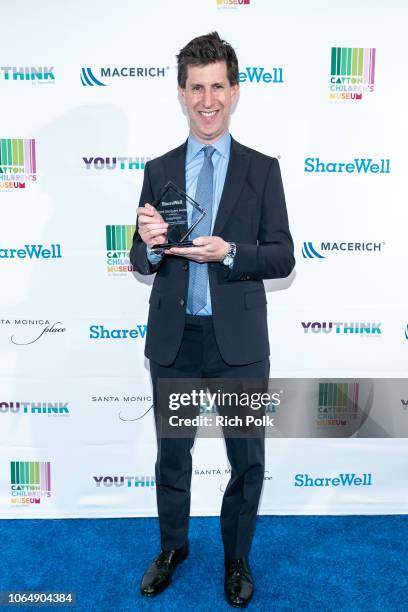 Recipient of the 2018 ShareWell Discovery Award, Craig Erwich poses for a photo with his award at the annual ShareWell/Zimmer Children's Museum...