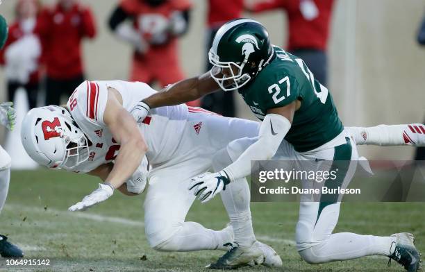 Tight end Travis Vokolek of the Rutgers Scarlet Knights scores past safety Khari Willis of the Michigan State Spartans on a pass play during the...