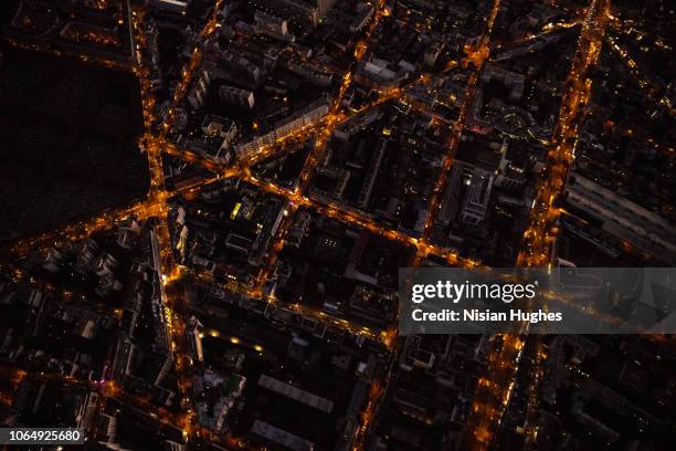 aerial flying over streets of paris france at night - street light photos et images de collection