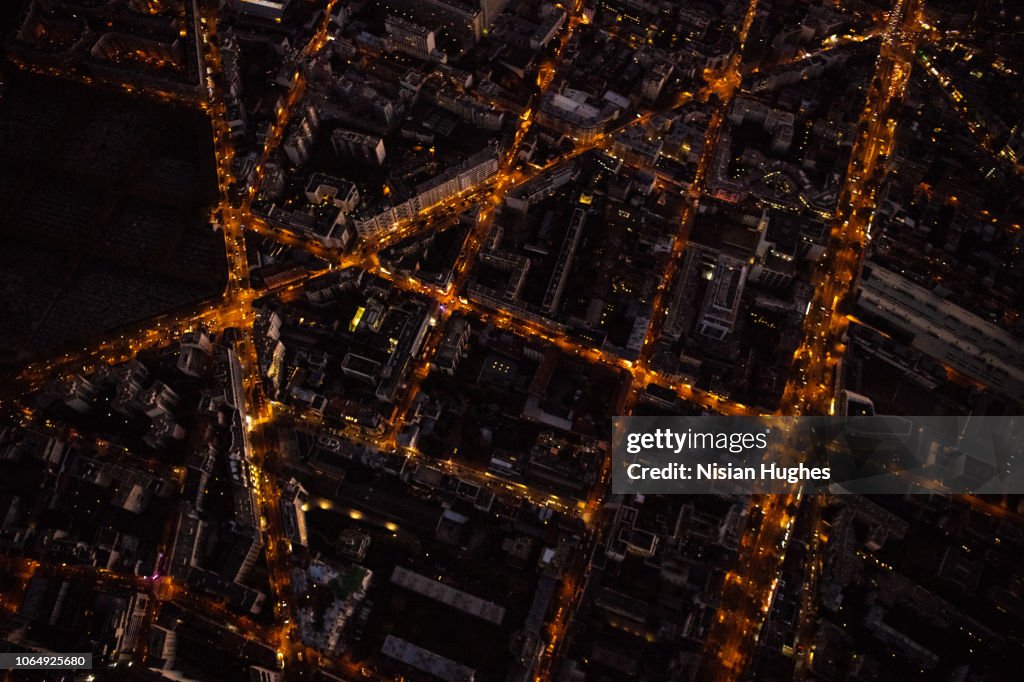 Aerial flying over streets of Paris France at night