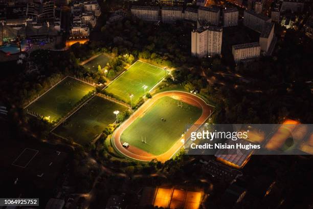 aerial flying over sports complex in paris france - rugby pitch stock-fotos und bilder