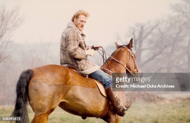 Drummer Ginger Baker poses for a photo on his horse circa 1975.