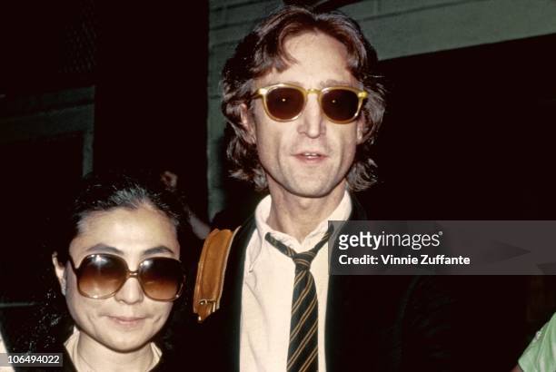 Former Beatle John Lennon and his wife Yoko Ono pose for a portrait outside of the Times Square recording studio 'The Hit Factory' before a recording...