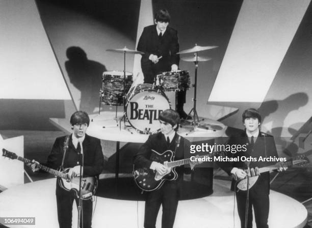 View of the members of British Rock group the Beatles as they perform onstage on 'The Ed Sullivan Show' at CBS's Studio 50, New York, New York,...
