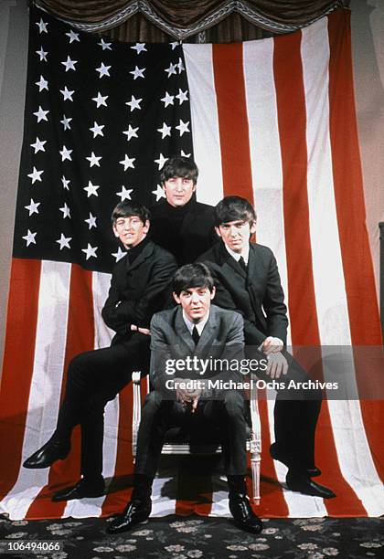 The Beatles pose for a portrait in front of an American Flag, New York City, 1964. Clockwise from top: John Lennon , George Harrison , Paul McCartney...