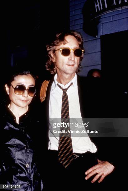 Former Beatle John Lennon and his wife Yoko Ono outside of the Times Square recording studio 'The Hit Factory' before a recording session of his...