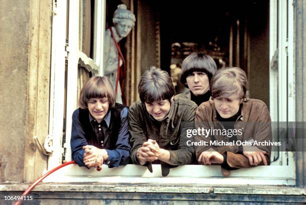 The Beatles Ringo Starr, Paul McCartney, George Harrison and John Lennon at a window of Cliveden House in Buckinghamshire during the filming of...