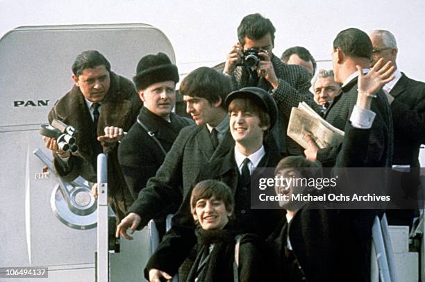 The Beatles arrive at Kennedy Airport for the first time from London for a 10-day tour on February 7, 1964 in New York City, New York.