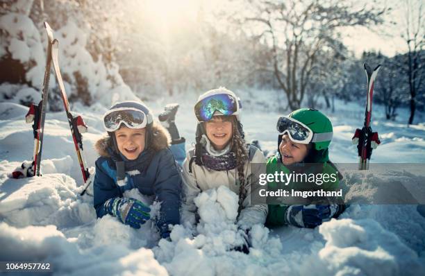 happy kids skiing in beautiful winter forest - ski gear stock pictures, royalty-free photos & images