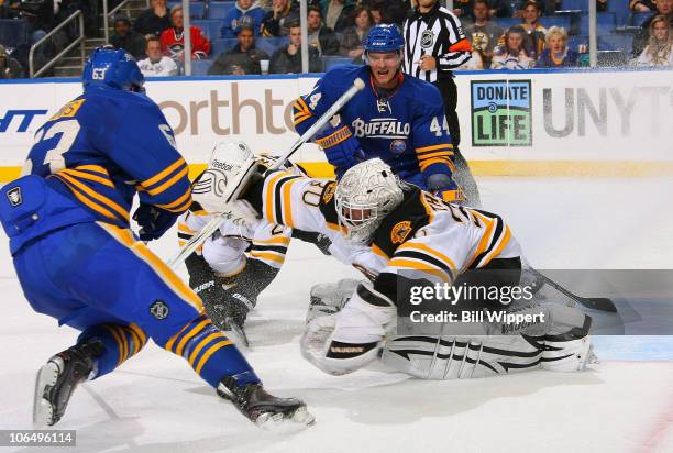 Tim Thomas of the Boston Bruins makes a save against Tyler Ennis and Andrej Sekera of the Buffalo Sabres at HSBC Arena on November 3, 2010 in...