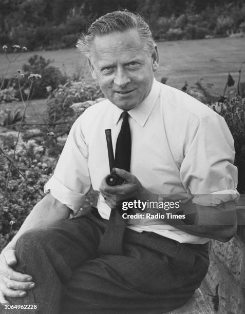 Gardener and television presenter Percy Thrower pictured in his garden with a pipe, photographed for Radio Times in connection with the magazine...