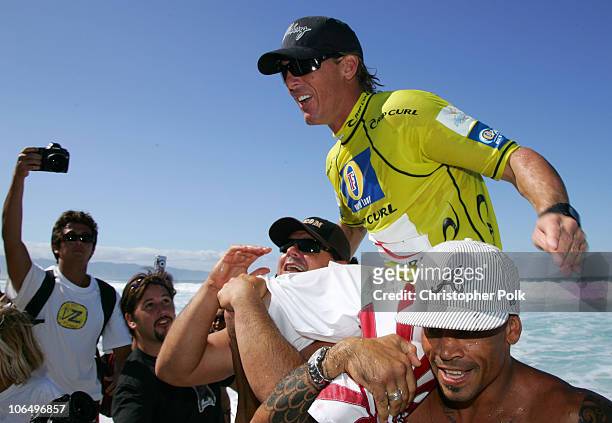 Andy Irons, top and winner of both the Rip Curl Pro Pipeline Masters and the Vans Triple Crown of Surfingis carried by local surfers to the awards...