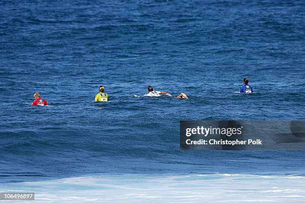 Mick Fanning, red, Andy Irons, yellow, Kalani Chapman, white, and Bruce Irons, blue, surf during the final round of the Rip Curl Pro Pipeline Masters...