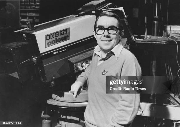 Portrait of comedian Ronnie Corbett standing next to a BBC TV Colour camera, February 25th 1978.