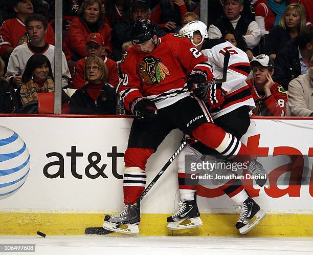 Jack Skille of the Chicago Blackhawks collides with Jamie Langenbrunner of the New Jersey Devils as they battle for the puck at the United Center on...
