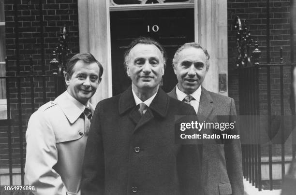 Actors Derek Fowlds, Paul Eddington and Nigel Hawthorne outside 10 Downing Street, in a scene from the television sitcom 'Yes Minister', London,...