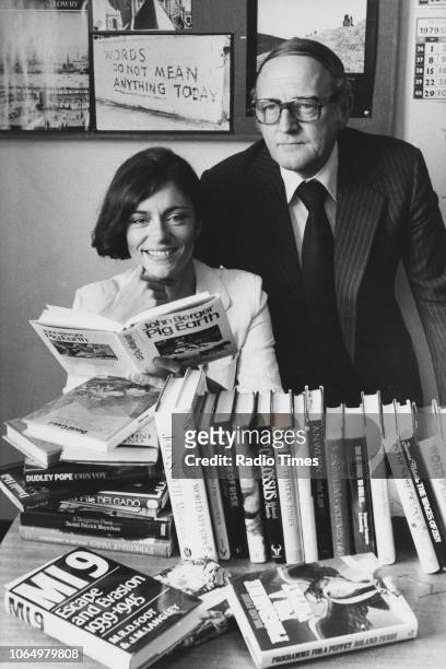 Portrait of actress Diana Quick and broadcaster Robert Robinson with a pile of books, photographed at BBC Television Centre for Radio Times in...