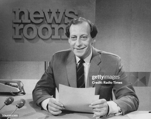 Journalist Peter Woods pictured smoking his pipe on the set of the television series 'Newsroom', May 1971.
