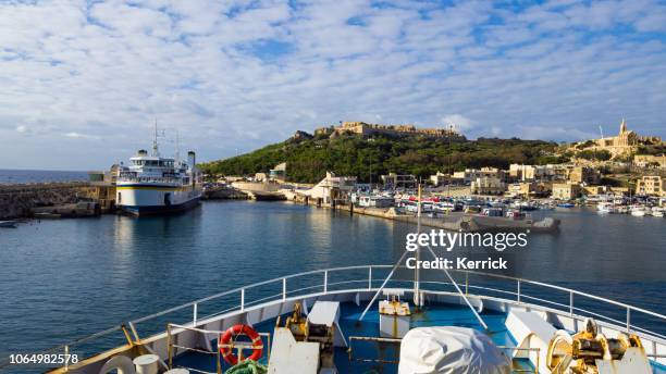 ferry entrance into the harbor of mgarr - island gozo, malta - island of gozo mgarr stock pictures, royalty-free photos & images