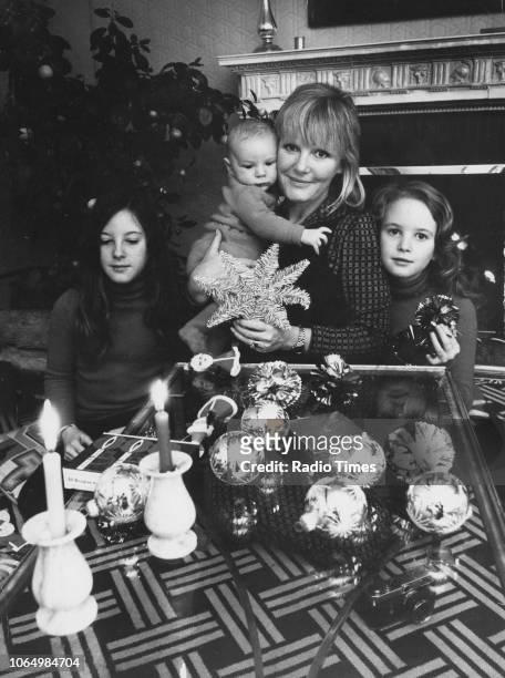 Portrait of singer Petula Clark and her children Katherine, Patrick and Barbara, surrounded by Christmas decorations at their home, November 28th...