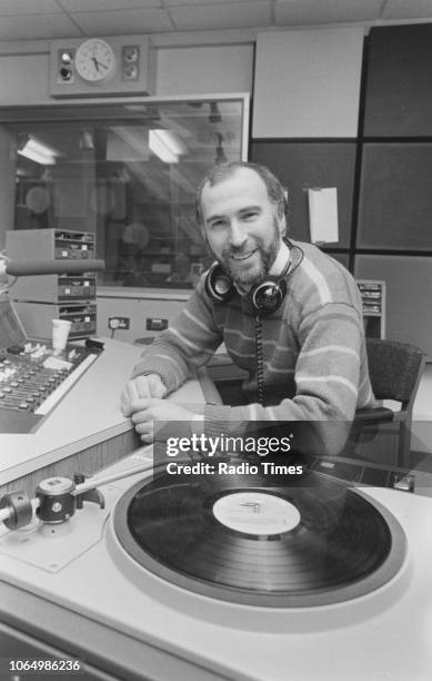 Portrait of radio host Ken Bruce in the studio, photographed for Radio Times in connection with his self titled BBC Radio 2 show, January 1984. First...