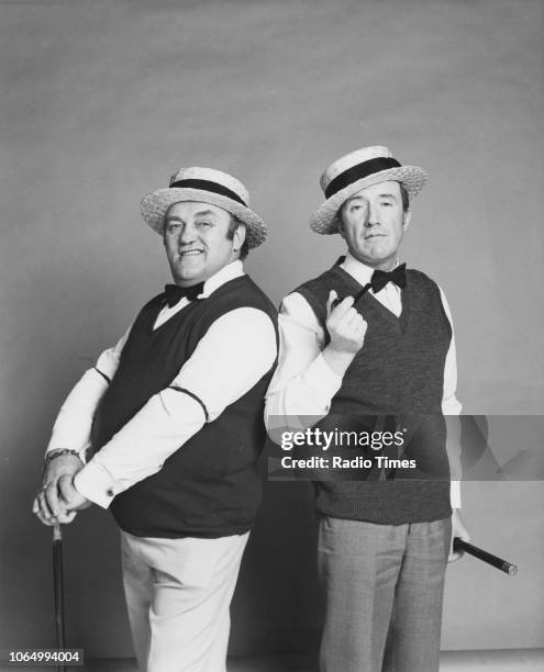 Portrait of comedian Les Dawson and dancer Roy Castle wearing matching outfits, photographed for Radio Times in connection with the BBC Radio 2 show...