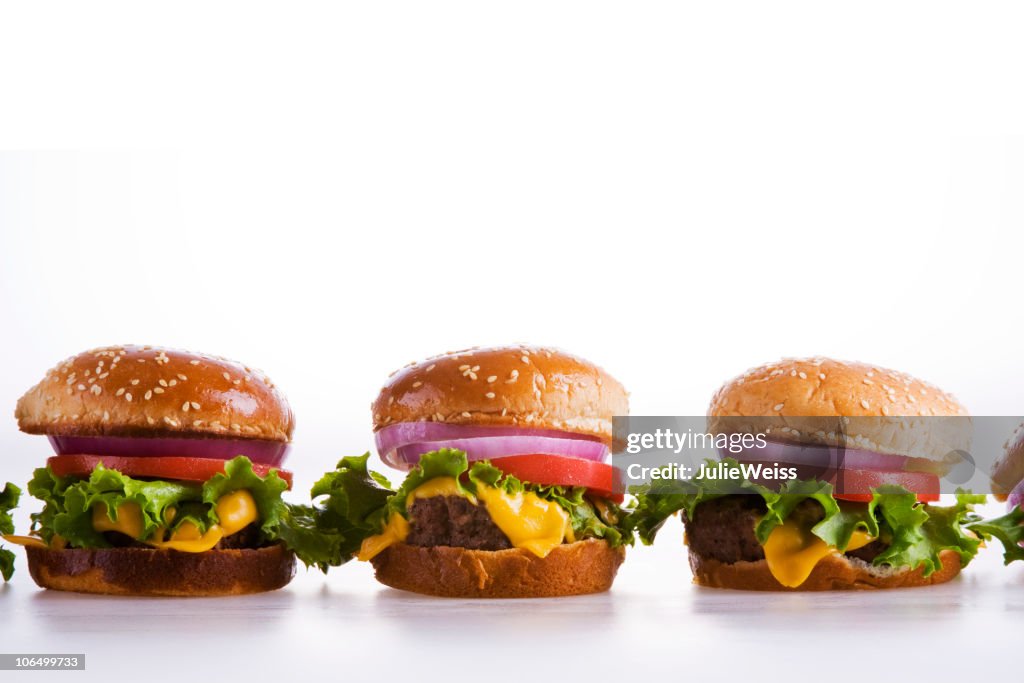 A row of cheeseburgers with classic toppings