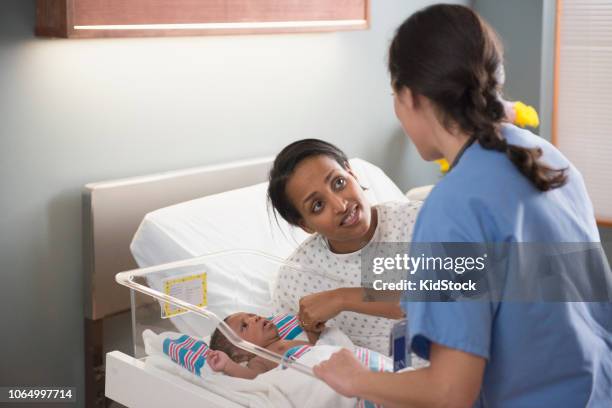 nurse checking newborn baby at hospital - black premature babies stock pictures, royalty-free photos & images