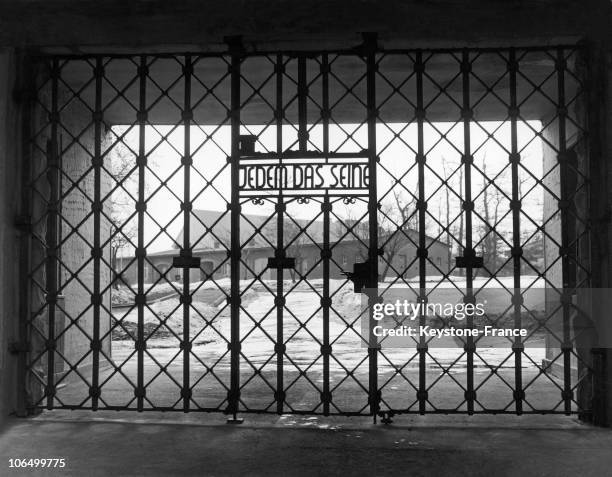 Steel Gate At The Extermination And Concentration Camp In Buchenwald On Which Can Be Read "Jedem Das Seine" . In The Background, The Barracks. The...