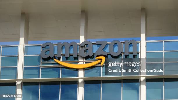 Close-up of sign with logo on facade of the regional headquarters of ecommerce company Amazon in the Silicon Valley town of Sunnyvale, California,...