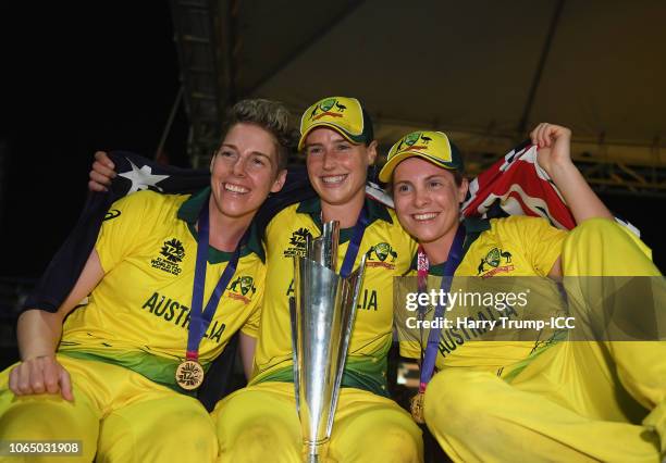 Elyse Villani, Ellyse Perry and Sophie Molineux of Australia celebrate during the ICC Women's World T20 2018 Final between Australia and England at...