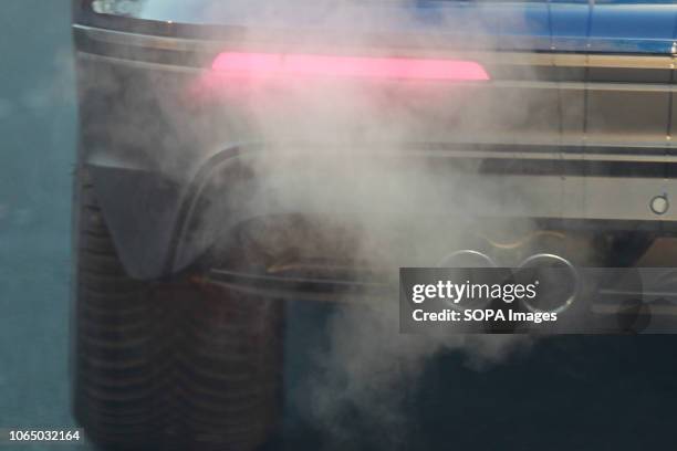 Car seen emitting exhaust fumes on the Street In Cologne. A ban on diesel vehicles with Euro 4 engines or older engines as well as for petrol engines...