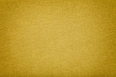 Golden matt suede fabric closeup. Velvet texture.