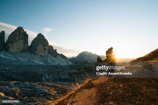 female hiker looks at view at sunset - self exploration stock pictures, royalty-free photos & images