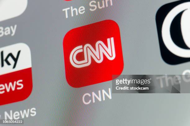 cnn, the guardian, sky news and other cellphone apps on iphone screen - cnn logo stock pictures, royalty-free photos & images