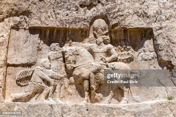 relief of triumph of shapur i over roman emperors valerian and philip arab, naqsh-e rustam, persepolis, iran - mesopotamian ストックフォトと画像