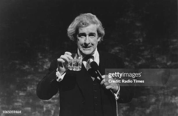 Comedian Dave Allen taking a drink as he performs on a television show, October 6th 1989.