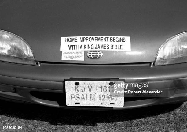 Car parked at Daytona International Speedway in Daytona Beach, Florida, displays signs declaring the car owner's conservative Christian faith.